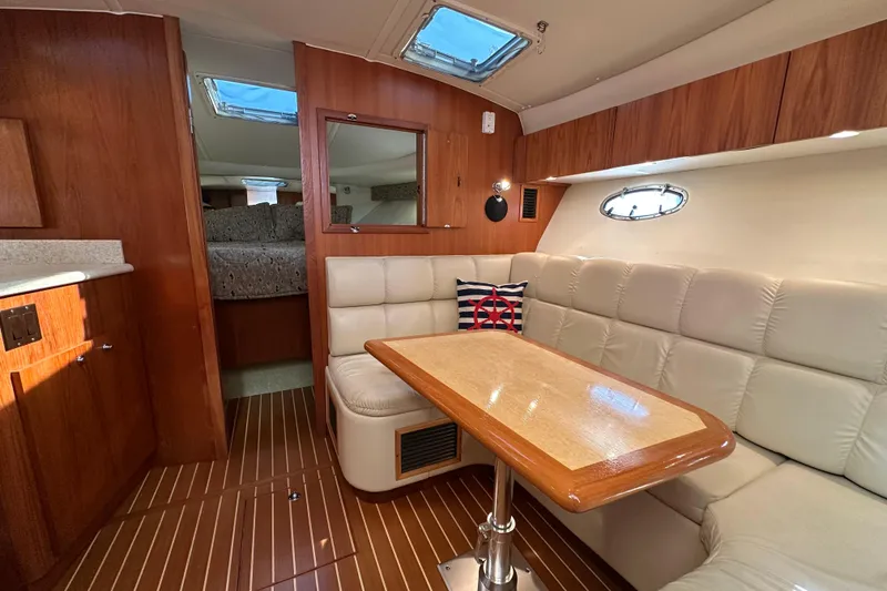 Slide: The Image of Interior of 2001 Tiara Yachts 3500 Open with plush seating and nautical decor. - 21