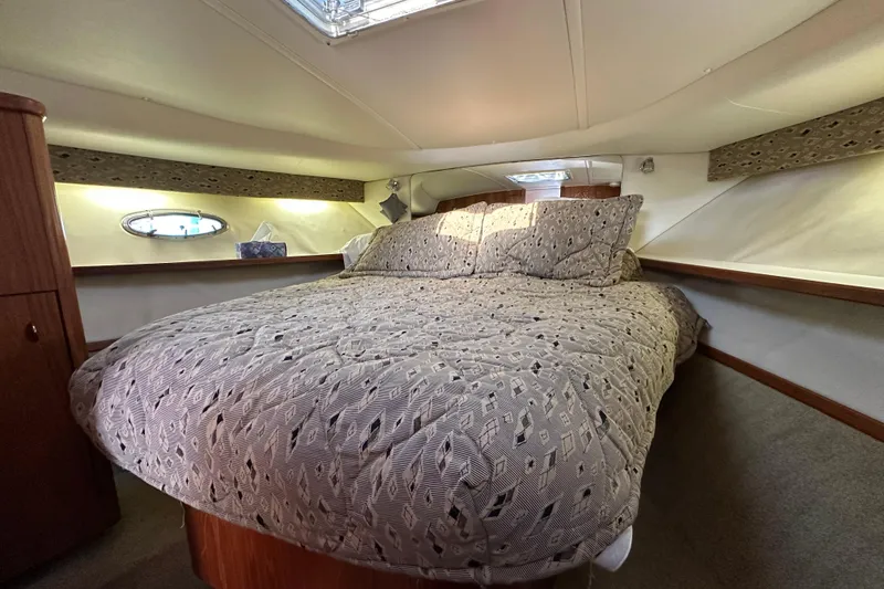 Slide: The Image of Cozy cabin interior of 2001 Tiara Yachts 3500 Open with patterned bedding. - 28