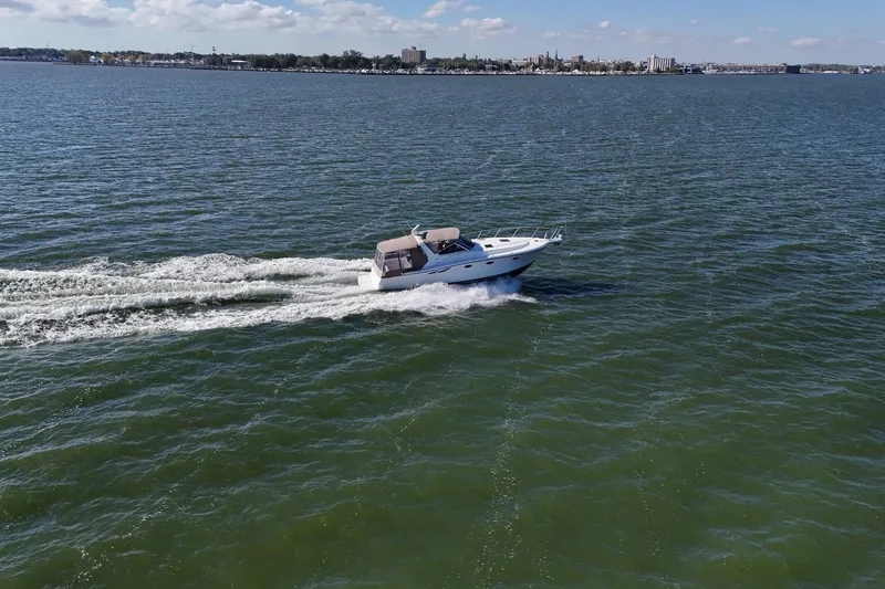 Slide: The Image of 2001 Tiara Yachts 3500 Open cruising on a vast, calm sea under a clear sky. - 31