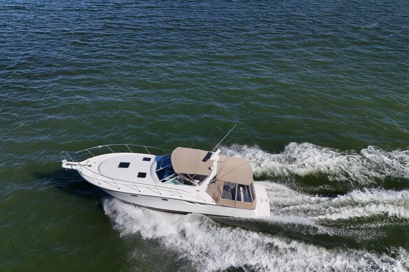 Slide: The Image of A 2001 Tiara Yachts 3500 Open cruising on a vast, serene blue ocean. - 35