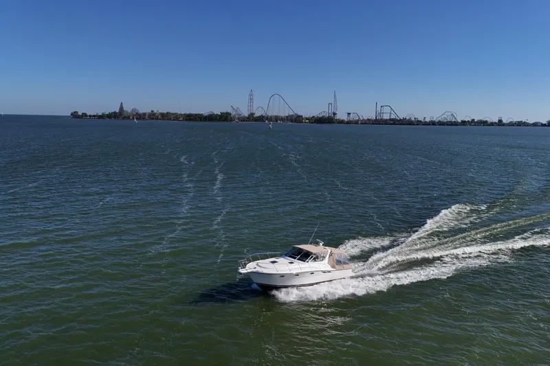 Slide: The Image of 2001 Tiara Yachts 3500 Open cruising on open water, creating a dynamic wake. - 36