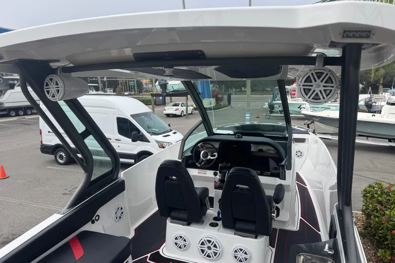 Slide: The Image of 2025 Monterey Elite 27 OB boat interior with modern dashboard and seating. - 10