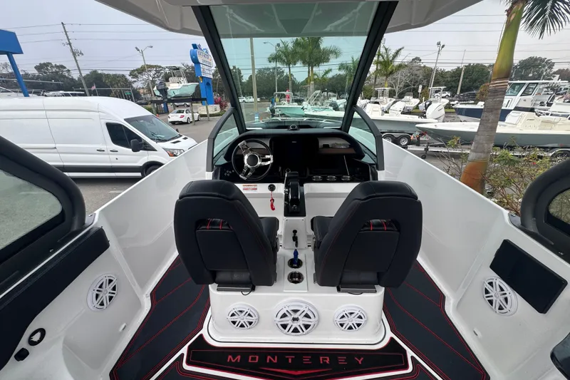 Slide: The Image of Interior view of 2025 Monterey Elite 27 OB boat, featuring dual seats and modern dashboard. - 19