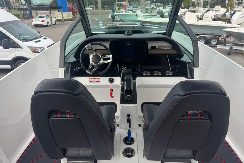 Slide: The Image of 2025 Monterey Elite 27 OB boat cockpit with dual seats and modern steering console. - 20
