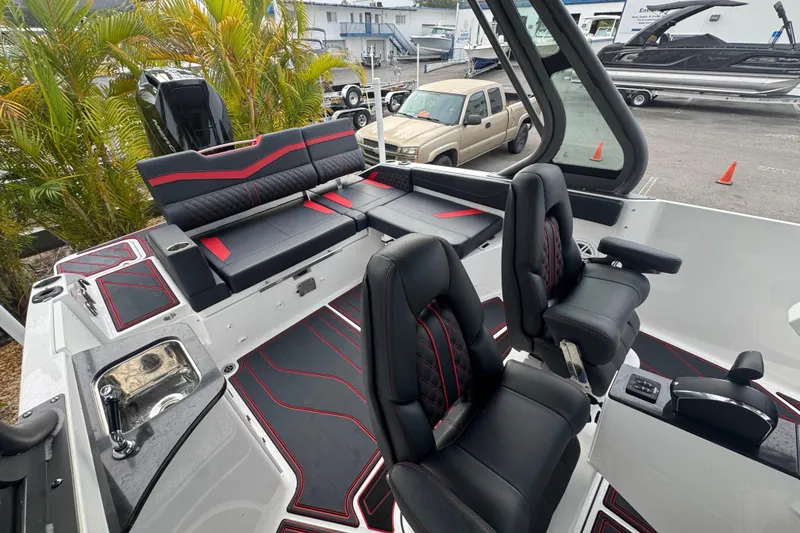 Slide: The Image of 2025 Monterey Elite 27 OB boat interior with black and red seating, modern design. - 25