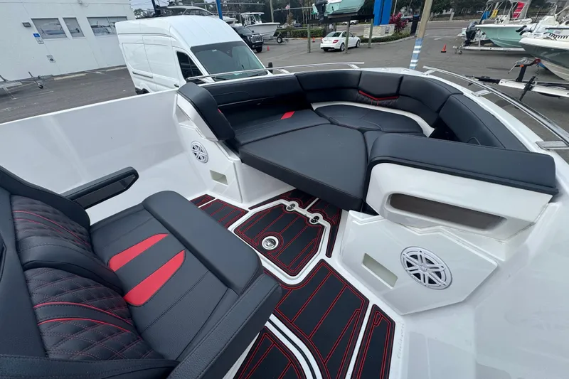 Slide: The Image of Luxurious seating on 2025 Monterey Elite 27 OB boat with stylish black and red accents. - 28
