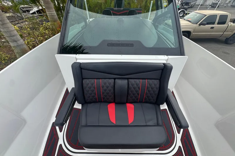 Slide: The Image of 2025 Monterey Elite 27 OB boat interior with black and red seating, sleek design. - 29
