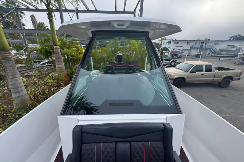 Slide: The Image of 2025 Monterey Elite 27 OB boat with sleek design, viewed from the front deck. - 30