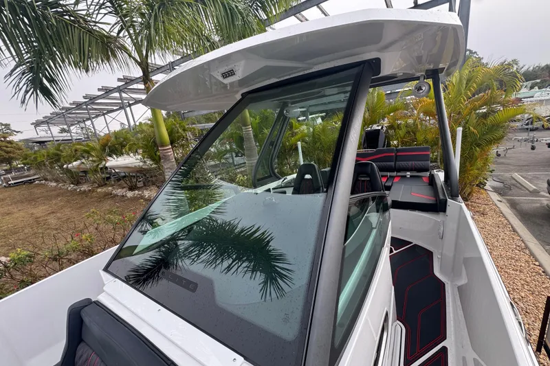 Slide: The Image of 2025 Monterey Elite 27 OB boat with sleek design, palm trees in background. - 31