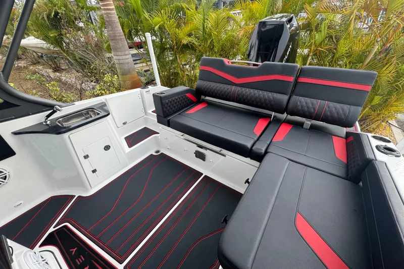 Slide: The Image of 2025 Monterey Elite 27 OB boat interior with black and red seating, sleek design. - 35