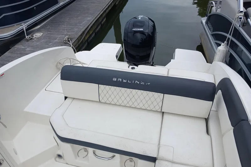 Slide: The Image of 2023 Bayliner DX 2200 boat with Mercury engine, docked at marina. - 14
