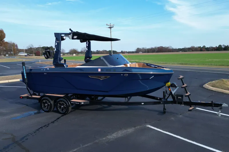 The Image of 2024 Nautique Super Air Nautique S21 boat on trailer in parking lot. - 1