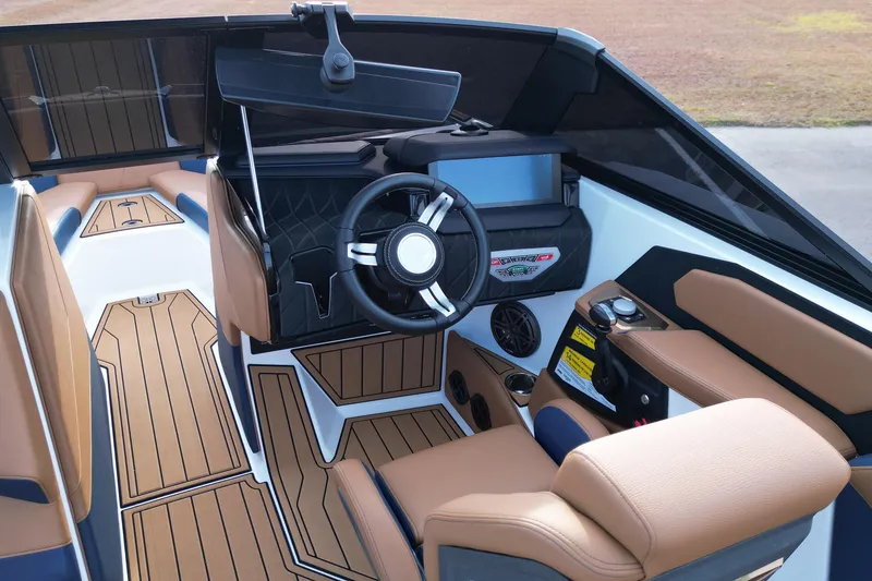 Slide: The Image of 2024 Nautique Super Air Nautique S21 interior with modern dashboard and luxurious seating. - 13