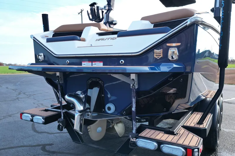 Slide: The Image of 2024 Nautique Super Air Nautique S21 boat rear view, showcasing sleek design and propeller. - 17