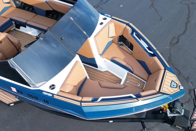 Slide: The Image of 2024 Nautique Super Air Nautique S21 boat interior with tan and blue seating. - 9