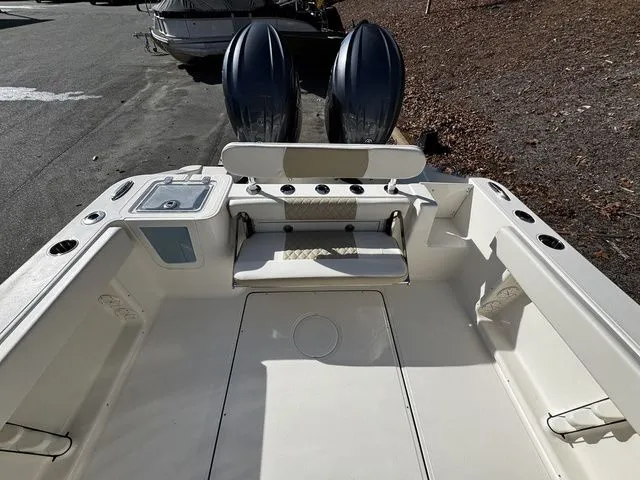 Slide: The Image of 2025 Bulls Bay 255CC boat interior with dual engines and seating area. - 12