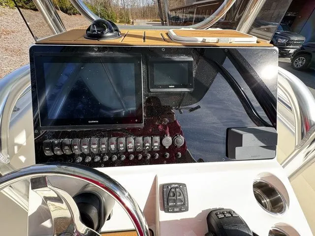 Slide: The Image of 2025 Bulls Bay 255CC boat dashboard with navigation screens and controls. - 7