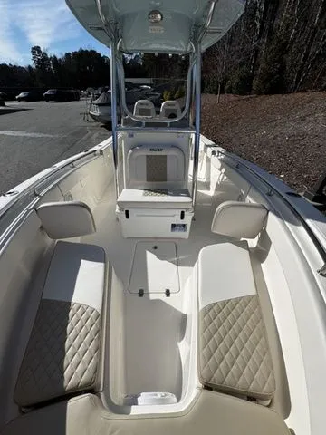 Slide: The Image of 2025 Bulls Bay 255CC boat interior with cushioned seating and center console. - 9
