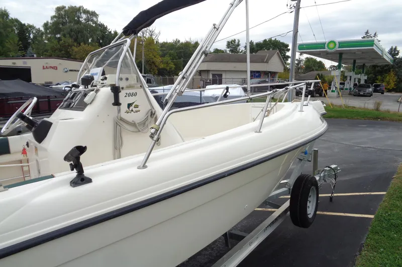Slide: The Image of 2001 Sea Master 2080 Center Console boat on trailer near gas station. - 15