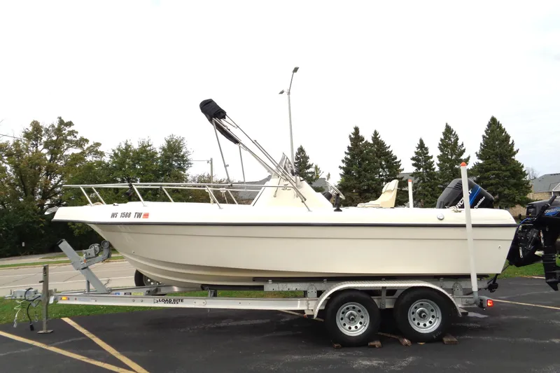 Slide: The Image of 2001 Sea Master 2080 Center Console boat on trailer, parked outdoors. - 2