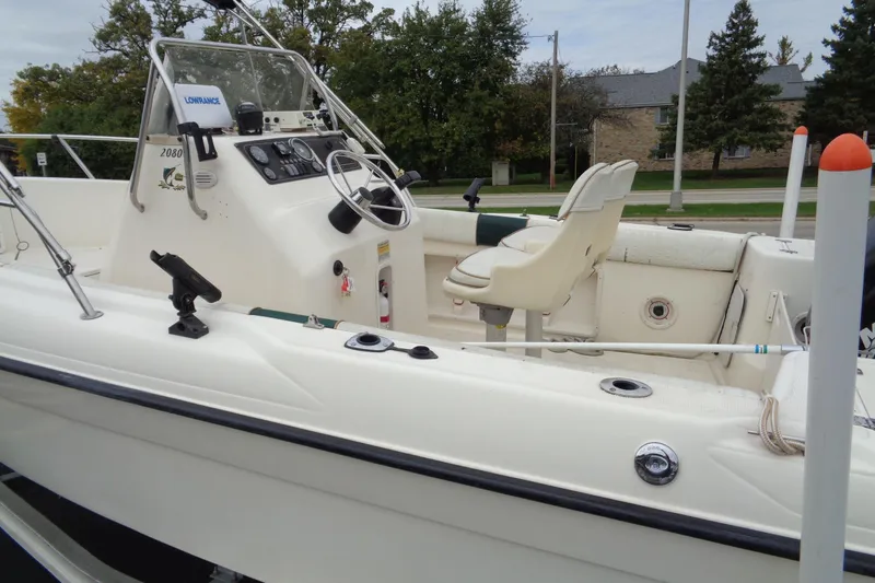 Slide: The Image of 2001 Sea Master 2080 Center Console boat with steering wheel and seating, docked outdoors. - 5