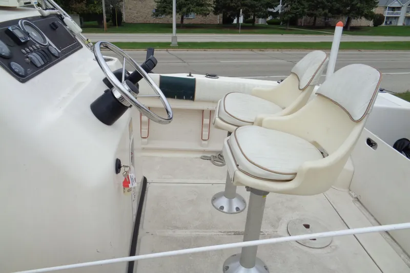 Slide: The Image of 2001 Sea Master 2080 Center Console boat interior with steering wheel and dual seats. - 9