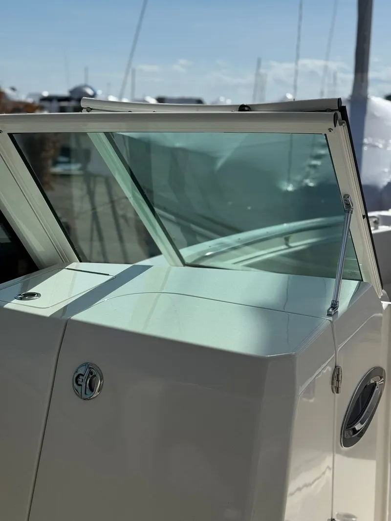 Slide: The Image of 2023 Sailfish 276DC boat windshield and console detail in sunlight. - 13