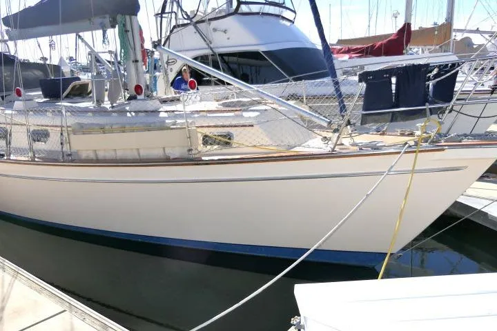 The Image of 1999 Island Packet 45 sailboat docked at marina, featuring classic design and sturdy build. - 1