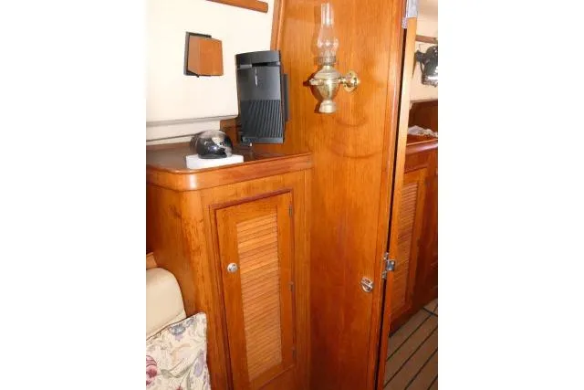 Slide: The Image of Interior of 1999 Island Packet 45 yacht with wooden cabinetry and vintage lamp. - 10