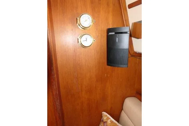 Slide: The Image of Interior of 1999 Island Packet 45 yacht with wooden panel, clock, and speaker. - 11
