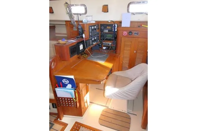 Slide: The Image of Navigation station of 1999 Island Packet 45 sailboat with wooden desk and electronics. - 17