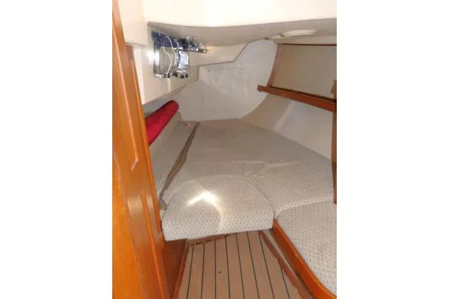 Slide: The Image of Interior cabin of 1999 Island Packet 45 sailboat with cozy bedding and wooden accents. - 19
