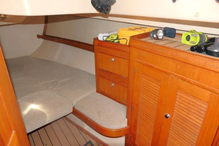 Slide: The Image of Cozy cabin interior of 1999 Island Packet 45 sailboat with wooden cabinetry and bed. - 20
