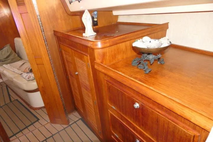 Slide: The Image of Interior of 1999 Island Packet 45 yacht with wooden cabinetry and decorative items. - 26