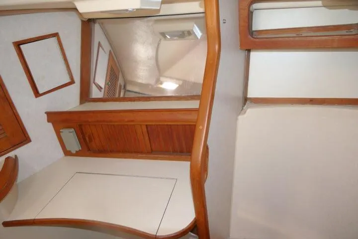 Slide: The Image of Interior of 1999 Island Packet 45 yacht with wooden accents and mirror. - 31