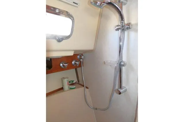 Slide: The Image of Shower area in 1999 Island Packet 45 sailboat with chrome fixtures. - 32
