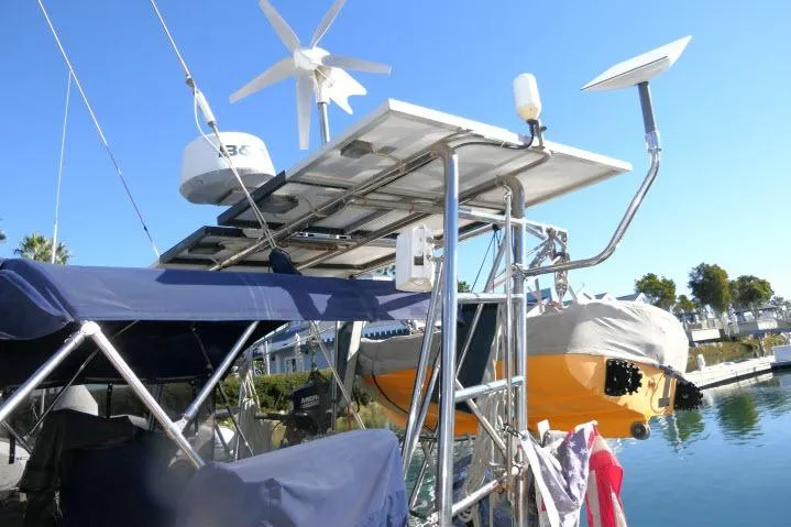 Slide: The Image of Sailboat with solar panels and wind turbine, Island Packet 45, 1999 model, docked in marina. - 35