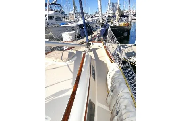 Slide: The Image of 1999 Island Packet 45 sailboat docked in a marina, showcasing deck and rigging. - 37