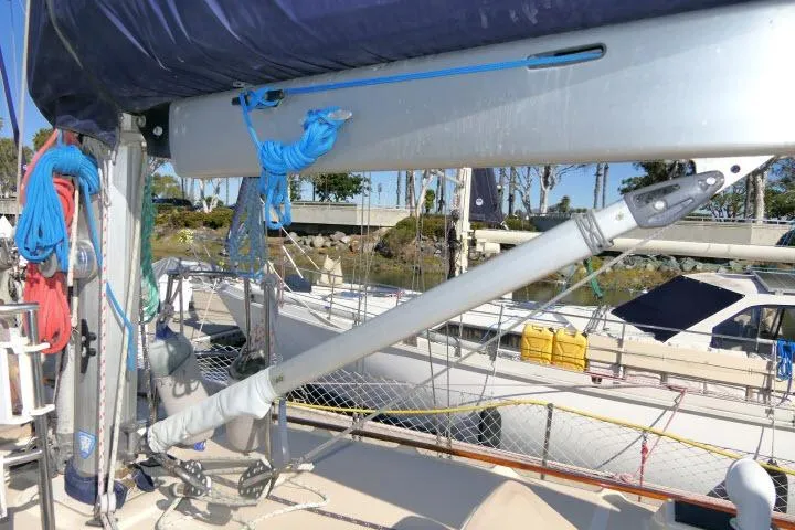 Slide: The Image of 1999 Island Packet 45 sailboat deck with rigging and boom, docked in marina. - 38