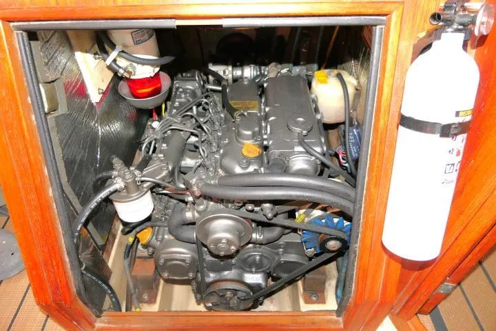 Slide: The Image of Engine compartment of a 1999 Island Packet 45 sailboat, featuring detailed mechanical components. - 47