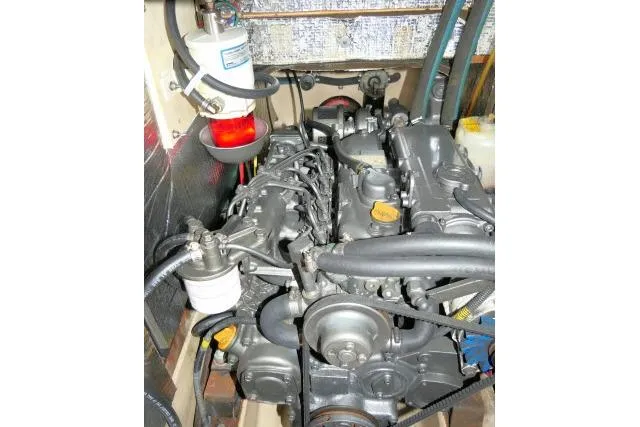 Slide: The Image of Engine compartment of a 1999 Island Packet 45 sailboat, showcasing mechanical components. - 49
