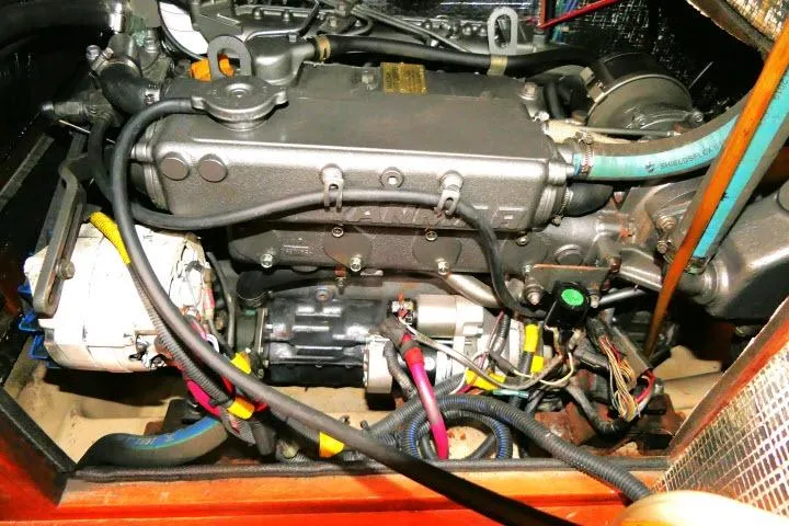 Slide: The Image of Engine compartment of a 1999 Island Packet 45 sailboat, showcasing detailed wiring and components. - 50