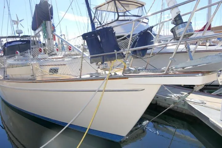 Slide: The Image of 1999 Island Packet 45 sailboat docked in marina, featuring sleek design and sturdy build. - 56