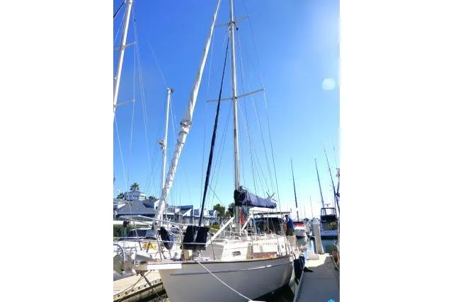 Slide: The Image of 1999 Island Packet 45 sailboat docked under clear blue sky. - 58