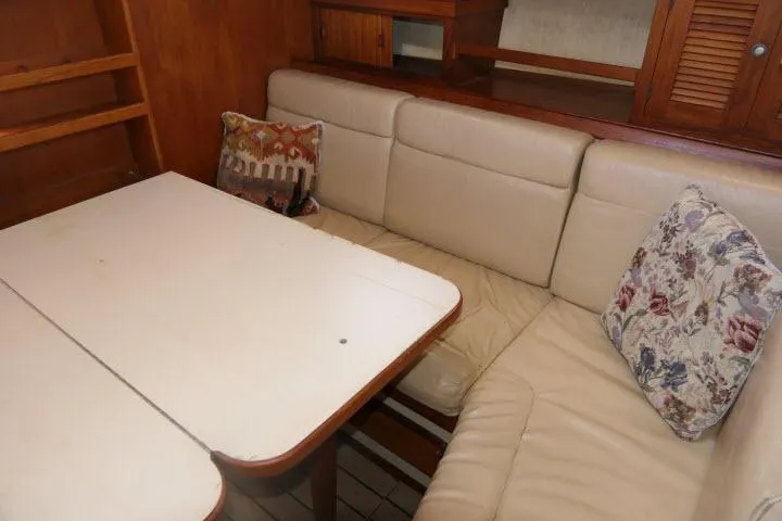 Slide: The Image of Interior of 1999 Island Packet 45 yacht with beige seating and decorative pillows. - 7
