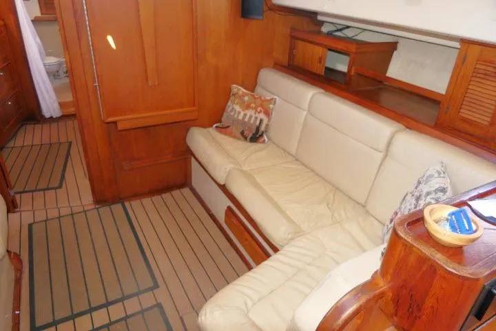 Slide: The Image of Interior of 1999 Island Packet 45 yacht with beige seating and wooden accents. - 8