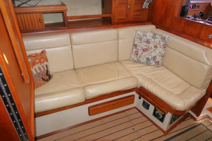 Slide: The Image of 1999 Island Packet 45 yacht interior with cream leather seating and decorative pillows. - 9
