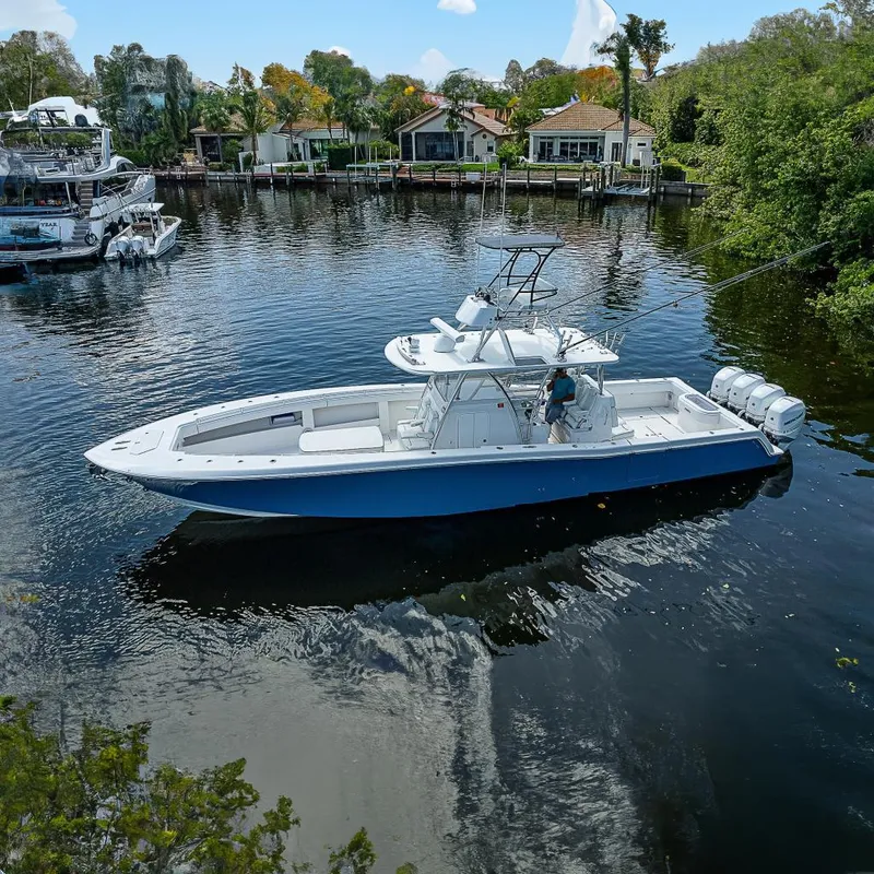 The Image of 2018 Invincible 42 boat on calm water, featuring sleek design and powerful engines. - 0