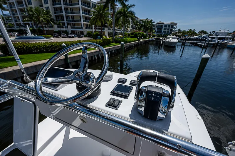 Slide: The Image of Steering console of 2018 Invincible 42 boat docked at marina with waterfront view. - 28