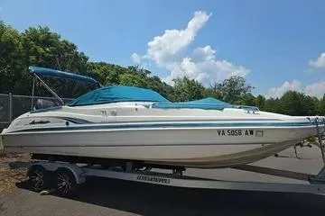 Slide: The Image of 2000 Hurricane SunDeck 237 OB boat on trailer, blue canopy, parked outdoors. - 7